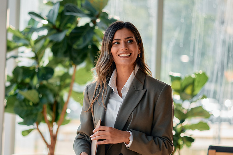 A business woman smiles directly into the camera