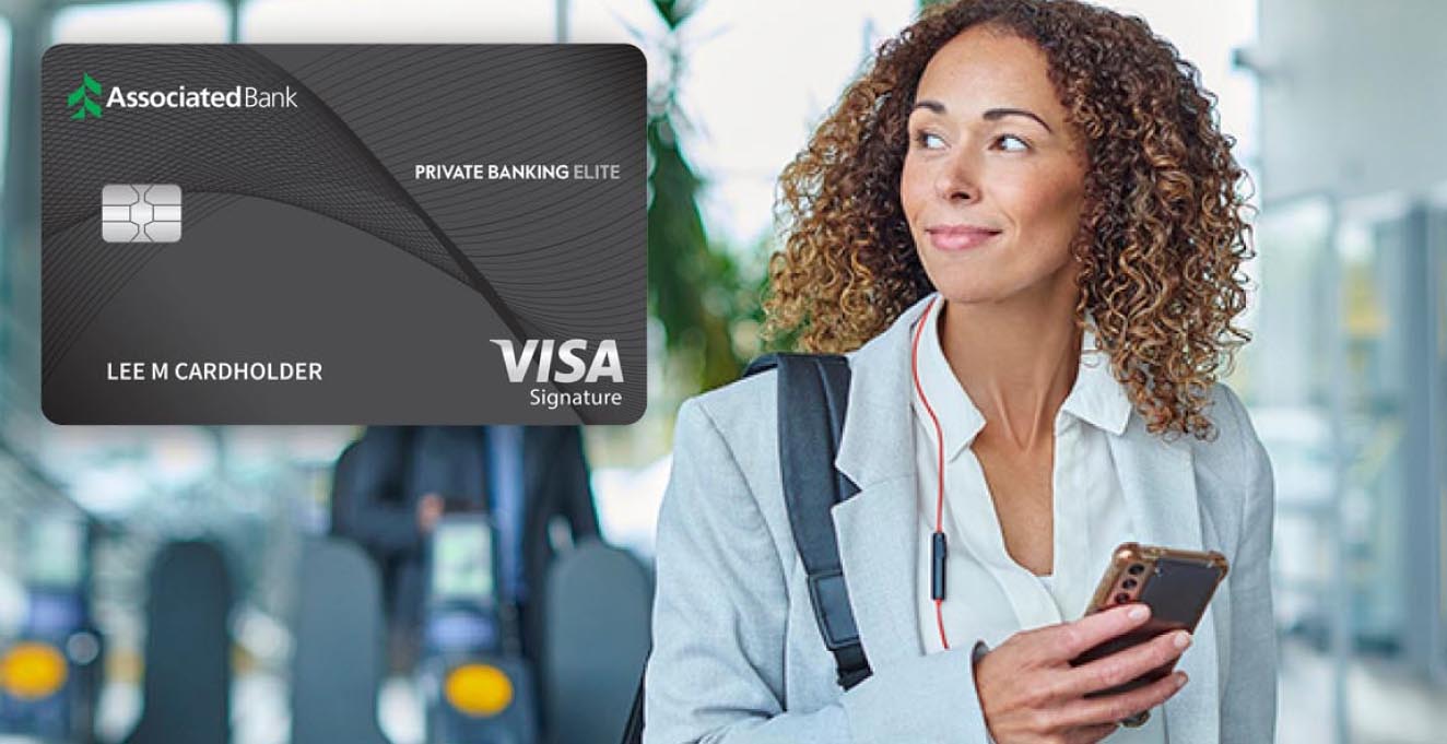 A business woman looks at the superimposed Associated Bank Private Banking Elite credit card