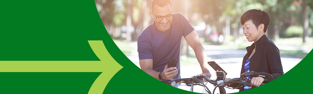 Friends using phones to transfer money while biking together