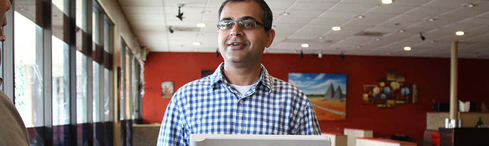 Waiter taking payment with Clover kiosk