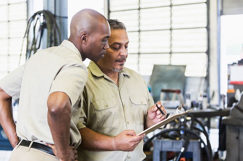 Mechanic business owners looking over information