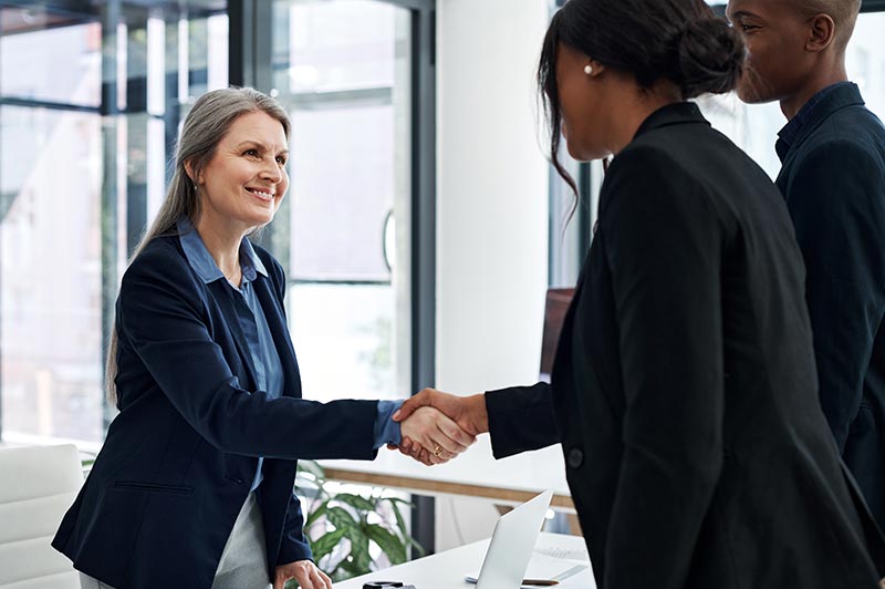 Banker shaking hands with Business Owners