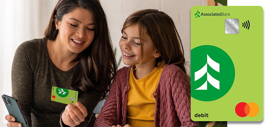 A mother and daughter reviewing a debit card together.