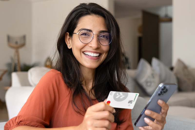 Woman holding Associated Bank debit card