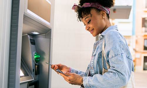 Woman getting cash out of the ATM
