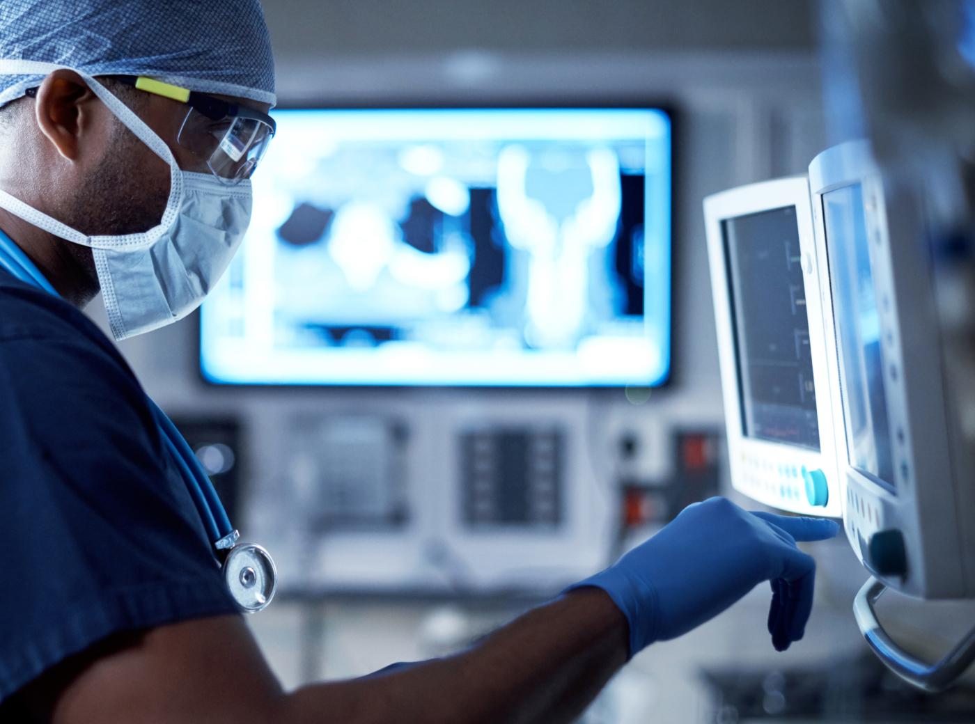 A doctor looks at a medical monitor in the operating room