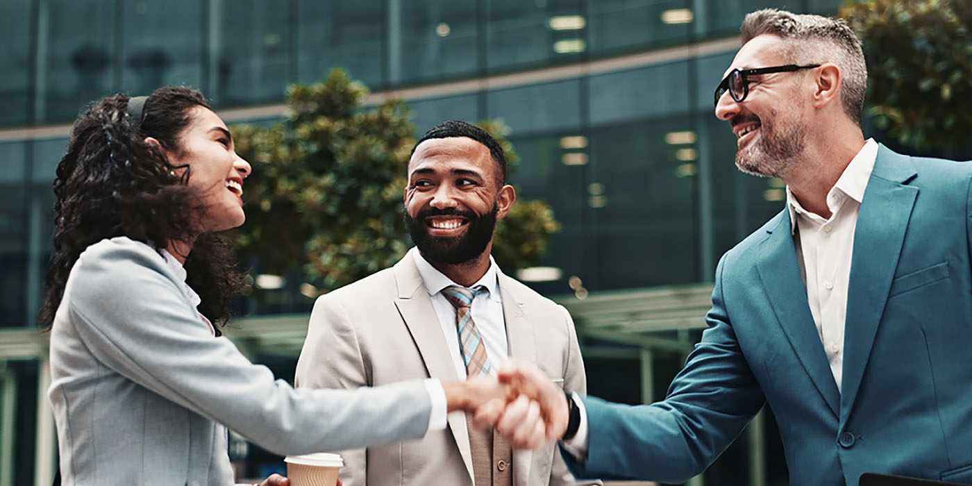 Three business people meet outside