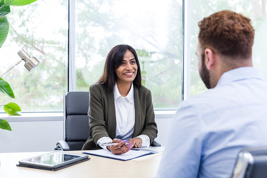 A business woman speaks to a business man
