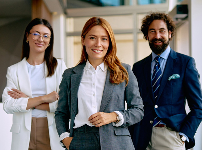A businessman with glasses smiles at the camera